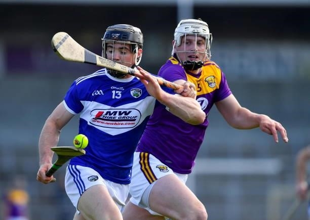 Kilkenny , Ireland - 26 June 2021; PJ Scully of Laois in action against Liam Ryan of Wexford during the Leinster GAA Hurling Senior Championship...