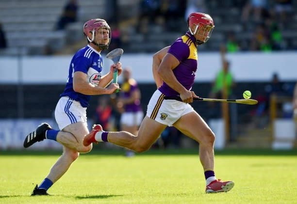 Kilkenny , Ireland - 26 June 2021; Lee Chin of Wexford in action against Ciaran Collier of Laois during the Leinster GAA Hurling Senior Championship...