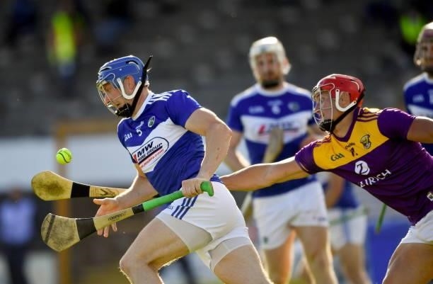 Kilkenny , Ireland - 26 June 2021; Stephen Maher of Laois in action against Lee Chin of Wexford during the Leinster GAA Hurling Senior Championship...