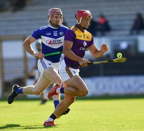 Kilkenny , Ireland - 26 June 2021; Lee Chin of Wexford in action against Ciaran Collier of Laois during the Leinster GAA Hurling Senior Championship...