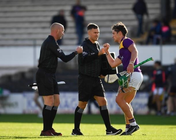 Kilkenny , Ireland - 26 June 2021; Conor McDonald of Wexford greets sideline official Nicky O'Toole and standby referee John Keenan after the...