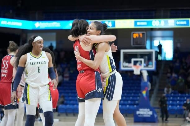 Isabelle Harrison of the Dallas Wings and Megan Gustafson of the Washington Mystics hug after the game on June 26, 2021 at the College Park Center in...