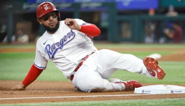 Jose Trevino of the Texas Rangers slides into third base against the Kansas City Royals during the second inning at Globe Life Field on June 26, 2021...