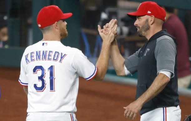 Ian Kennedy of the Texas Rangers celebrates the teams 8-0 win with manager Chris Woodward following the game against the Kansas City Royals at Globe...