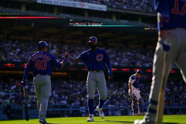 Willson Contreras of the Chicago Cubs fist bumps Jason Heyward during the game between the Chicago Cubs and the Los Angeles Dodgers at Dodgers...