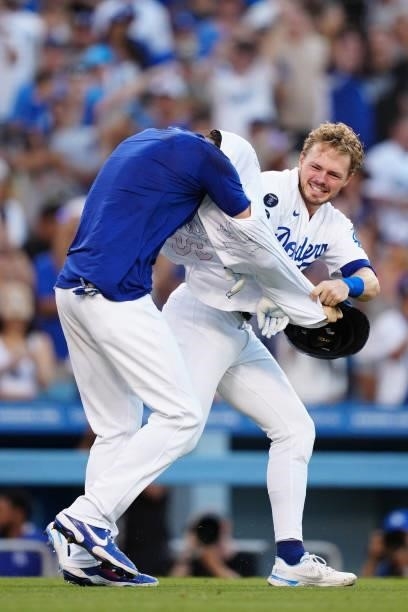 Cody Bellinger of the Los Angeles Dodgers gets his jersey ripped off by Gavin Lux after hitting a walk off home run during the game between the...