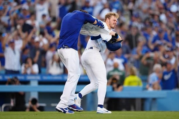Cody Bellinger of the Los Angeles Dodgers gets his jersey ripped off by Gavin Lux after hitting a walk off home run during the game between the...