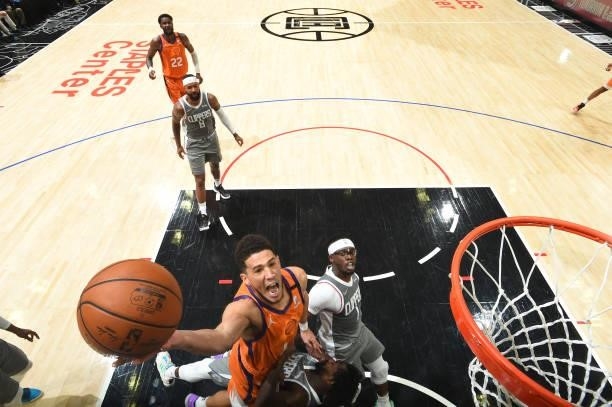Devin Booker of the Phoenix Suns drives to the basket as Patrick Beverley of the LA Clippers plays defense during Game 4 of the Western Conference...