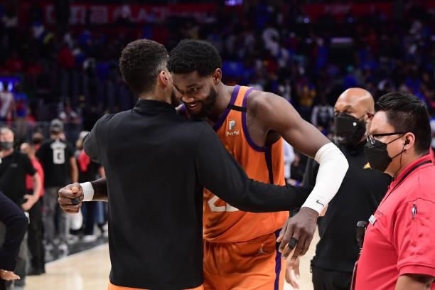 Deandre Ayton of the Phoenix Suns hugs Devin Booker of the Phoenix Suns after the game against the LA Clippers during Game 4 of the Western...