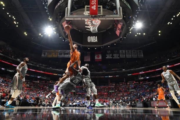 Devin Booker of the Phoenix Suns drives to the basket as Patrick Beverley of the LA Clippers plays defense during Game 4 of the Western Conference...