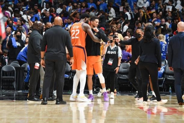 Deandre Ayton of the Phoenix Suns hugs Devin Booker of the Phoenix Suns after the game against the LA Clippers during Game 4 of the Western...