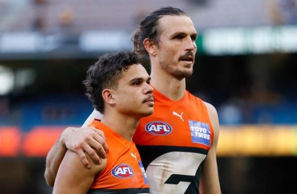 Bobby Hill and Phil Davis of the Giants look on during the 2021 AFL Round 15 match between the GWS Giants and the Hawthorn Hawks at the Melbourne...