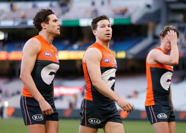 Josh Kelly, Toby Greene and Lachie Whitfield of the Giants look dejected after a loss during the 2021 AFL Round 15 match between the GWS Giants and...