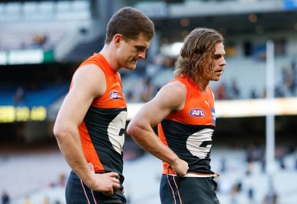 Jacob Hopper and Adam Kennedy of the Giants look dejected after a loss during the 2021 AFL Round 15 match between the GWS Giants and the Hawthorn...