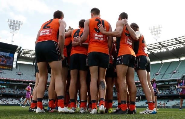 The Giants huddle during the 2021 AFL Round 15 match between the GWS Giants and the Hawthorn Hawks at the Melbourne Cricket Ground on June 27, 2021...