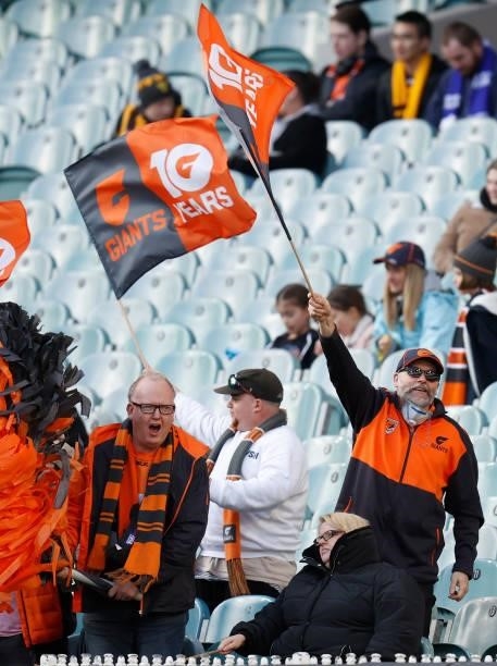 Giants fans cheer during the 2021 AFL Round 15 match between the GWS Giants and the Hawthorn Hawks at the Melbourne Cricket Ground on June 27, 2021...