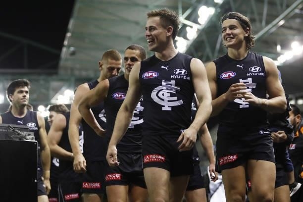 Matthew Owies and Liam Stocker of the Blues leave the field after a win during the 2021 AFL Round 15 match between the Carlton Blues and the Adelaide...