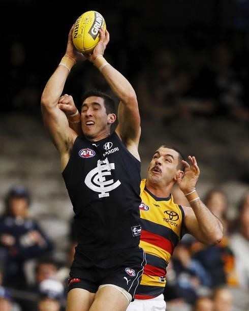 Jacob Weitering of the Blues marks the ball ahead of Taylor Walker of the Crows during the 2021 AFL Round 15 match between the Carlton Blues and the...