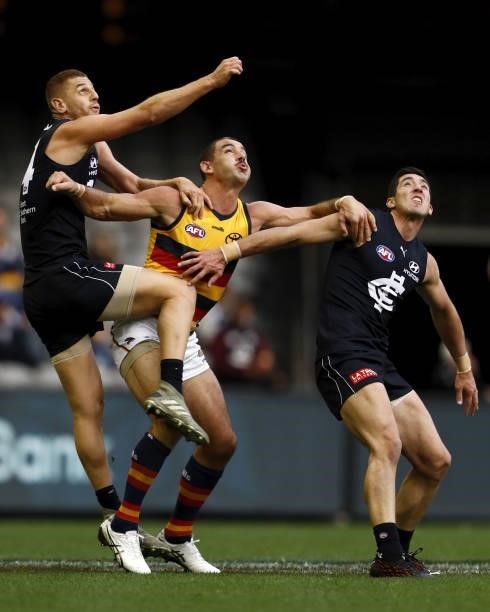 Liam Jones of the Blues, Taylor Walker of the Crows and Jacob Weitering of the Blues compete for the ball during the 2021 AFL Round 15 match between...