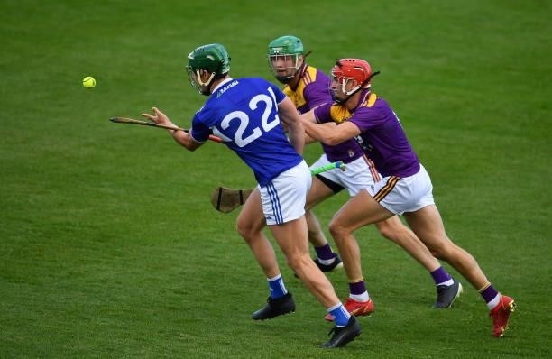 Kilkenny , Ireland - 26 June 2021; James Ryan of Laois in action against Ciaran McEvoy and Paddy Purcell of Laois, right, during the Leinster GAA...