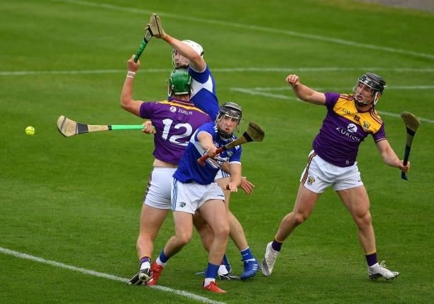Kilkenny , Ireland - 26 June 2021; Wexford players Conor McDonald and Mikie Dwyer, right, in action against Laois players Donnchadh Hartnett and Ryan...