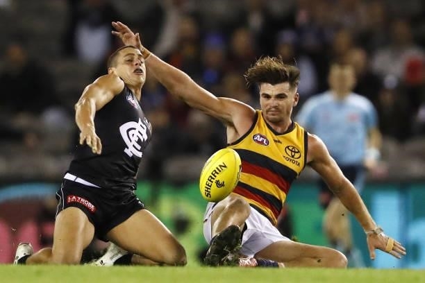 Ed Curnow of the Blues and Ben Keays of the Crows compete for the ball during the 2021 AFL Round 15 match between the Carlton Blues and the Adelaide...