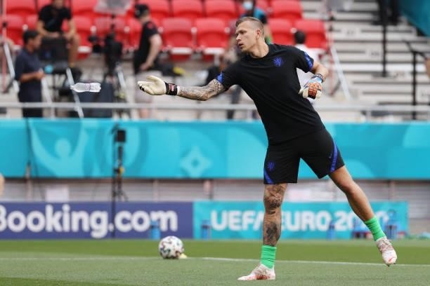 Netherlands' goalkeeper Marco Bizot throws a bottle of water as he warms up before the UEFA EURO 2020 round of 16 football match between the...