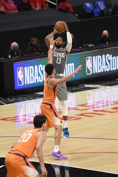 Paul George of the LA Clippers shoots the ball over Devin Booker of the Phoenix Suns during Game 4 of the Western Conference Finals of the 2021 NBA...