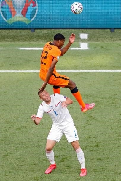 Netherlands' defender Denzel Dumfries jumps for the ball over Czech Republic's defender Pavel Kaderabek during the UEFA EURO 2020 round of 16...