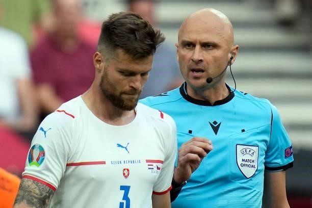 Russian referee Sergey Karasev speaks to Czech Republic's defender Ondrej Celustka during the UEFA EURO 2020 round of 16 football match between the...