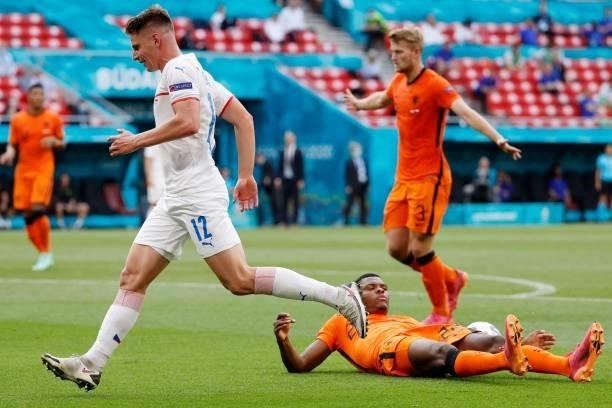 Czech Republic's midfielder Lukas Masopust jumps over Netherlands' defender Denzel Dumfries during the UEFA EURO 2020 round of 16 football match...