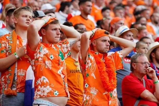Netherlands supporters react after their team conceded a second goal during the UEFA EURO 2020 round of 16 football match between the Netherlands and...