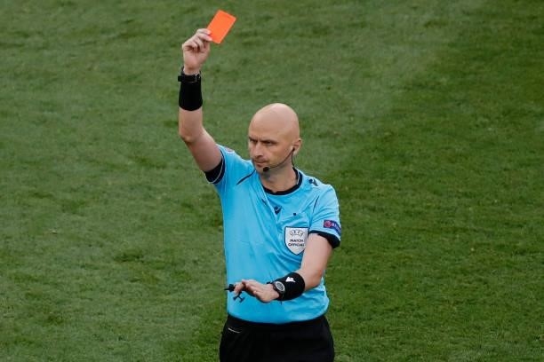Russian referee Sergey Karasev shows a red card to Netherlands' defender Matthijs de Ligt for a handball during the UEFA EURO 2020 round of 16...