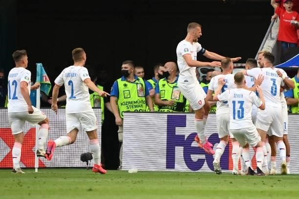 Czech Republic's midfielder Tomas Holes celebrates with teammates after scoring his team's first goal during the UEFA EURO 2020 round of 16 football...