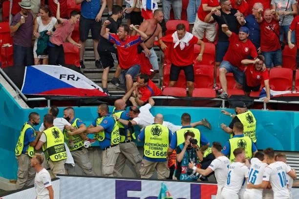 Stewards catch a supporter in the tribunes as Czech Republic's players celebrate their first goal during the UEFA EURO 2020 round of 16 football...