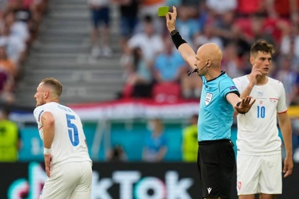Russian referee Sergey Karasev shows a yellow card to Czech Republic's defender Vladimir Coufal during the UEFA EURO 2020 round of 16 football match...