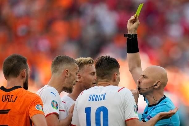 Russian referee Sergey Karasev shows a yellow card to Netherlands' defender Matthijs de Ligt which was later changed to red after a VAR review during...