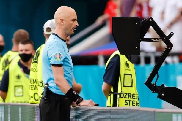 Russian referee Sergey Karasev reviews the VAR during the UEFA EURO 2020 round of 16 football match between the Netherlands and the Czech Republic at...