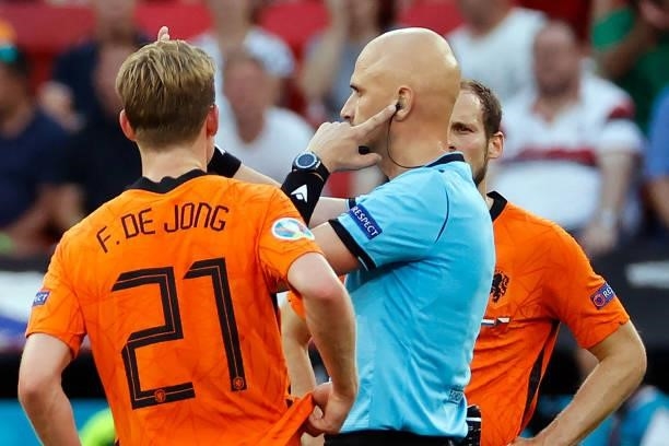 Russian referee Sergey Karasev listens to the VAR team during the UEFA EURO 2020 round of 16 football match between the Netherlands and the Czech...