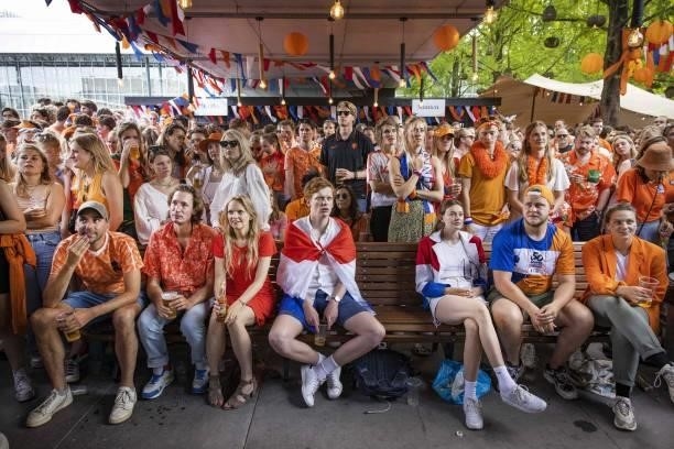 Football fans watch the UEFA EURO 2020 round of 16 football match between the Netherlands and the Czech Republic on a terrace in Amsterdam, the...