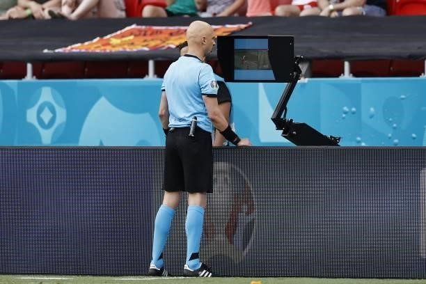 Referee Sergei Karasev watches VAR footage during the UEFA EURO 2020 match between the Netherlands and the Czech Republic at the Puskas Arena on June...