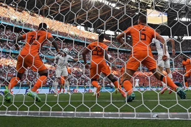 Czech Republic's midfielder Tomas Holes heads the ball and scors his team's first goal during the UEFA EURO 2020 round of 16 football match between...