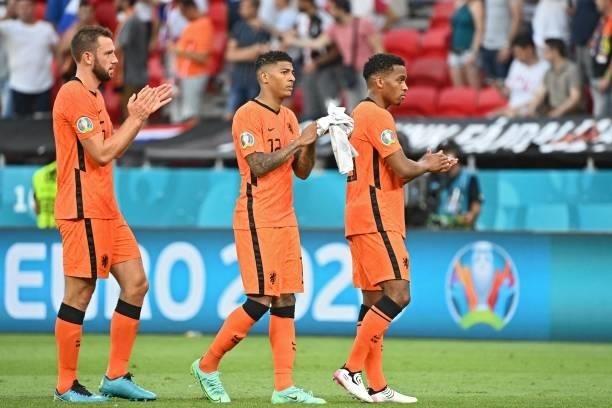 Netherlands' defender Stefan de Vrij , Netherlands' defender Patrick van Aanholt and Netherlands' forward Donyell Malen react after losing the UEFA...