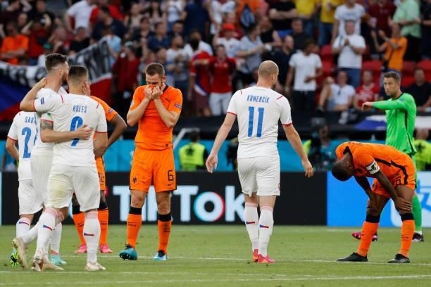 Netherlands' defender Stefan de Vrij and Netherlands' midfielder Georginio Wijnaldum react as Czech Republic's players celebrate at the end of the...