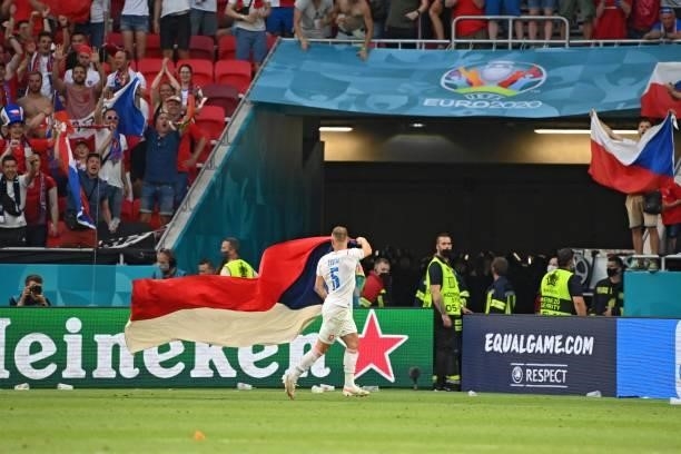 Czech Republic's defender Vladimir Coufal holds his national flag as he celebrates winning the UEFA EURO 2020 round of 16 football match between the...