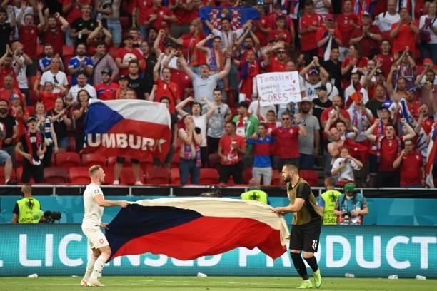 Czech Republic's defender Vladimir Coufal and Czech Republic's goalkeeper Tomas Koubek hold their national flag as they celebrate winning the UEFA...