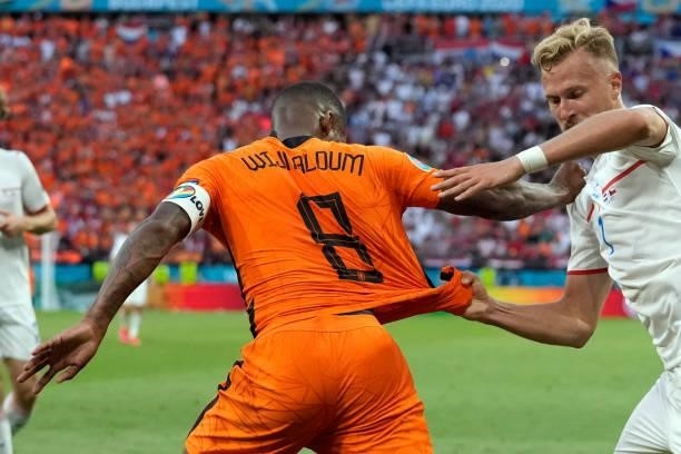 Czech Republic's midfielder Antonin Barak pulls the jersey of Netherlands' midfielder Georginio Wijnaldum during the UEFA EURO 2020 round of 16...