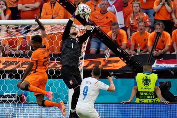 Czech Republic's goalkeeper Tomas Vaclik stops a shot on goal by Netherlands' defender Denzel Dumfries next to Czech Republic's midfielder Tomas...