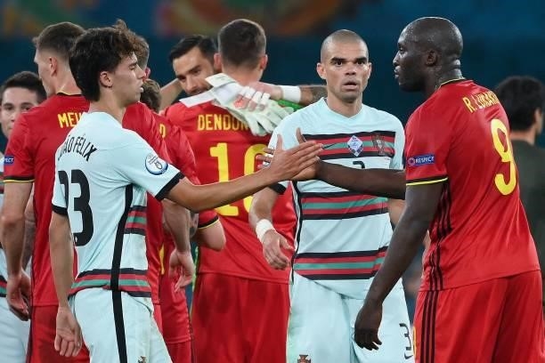 Portugal's forward Joao Felix and Portugal's defender Pepe congratulate Belgium's forward Romelu Lukaku for his team's victory at the end of the the...