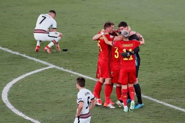 Belgium's players celebrate winning as Portugal's forward Cristiano Ronaldo reacts after the UEFA EURO 2020 round of 16 football match between...